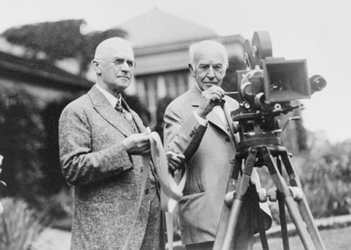 Thomas Edison and George Eastman standing with motion picture camera.